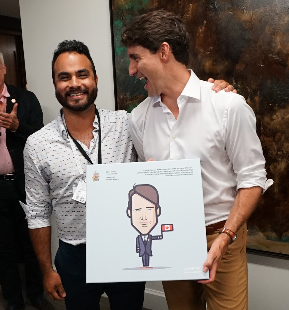 Prime Minister Justin Trudeau holding his Loogmoji caricature by Loogart