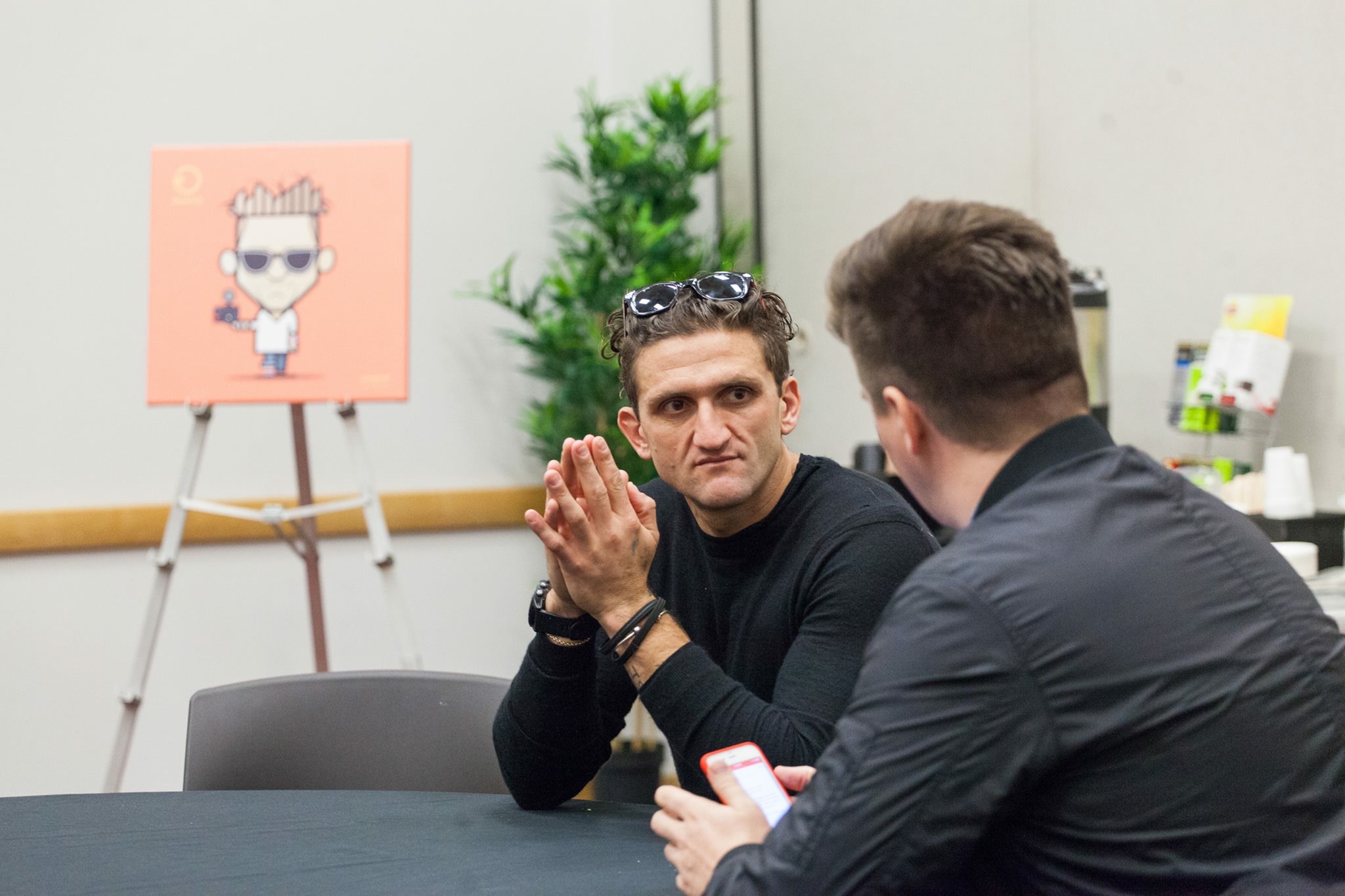 Casey Neistat with his Loogmoji on an easel